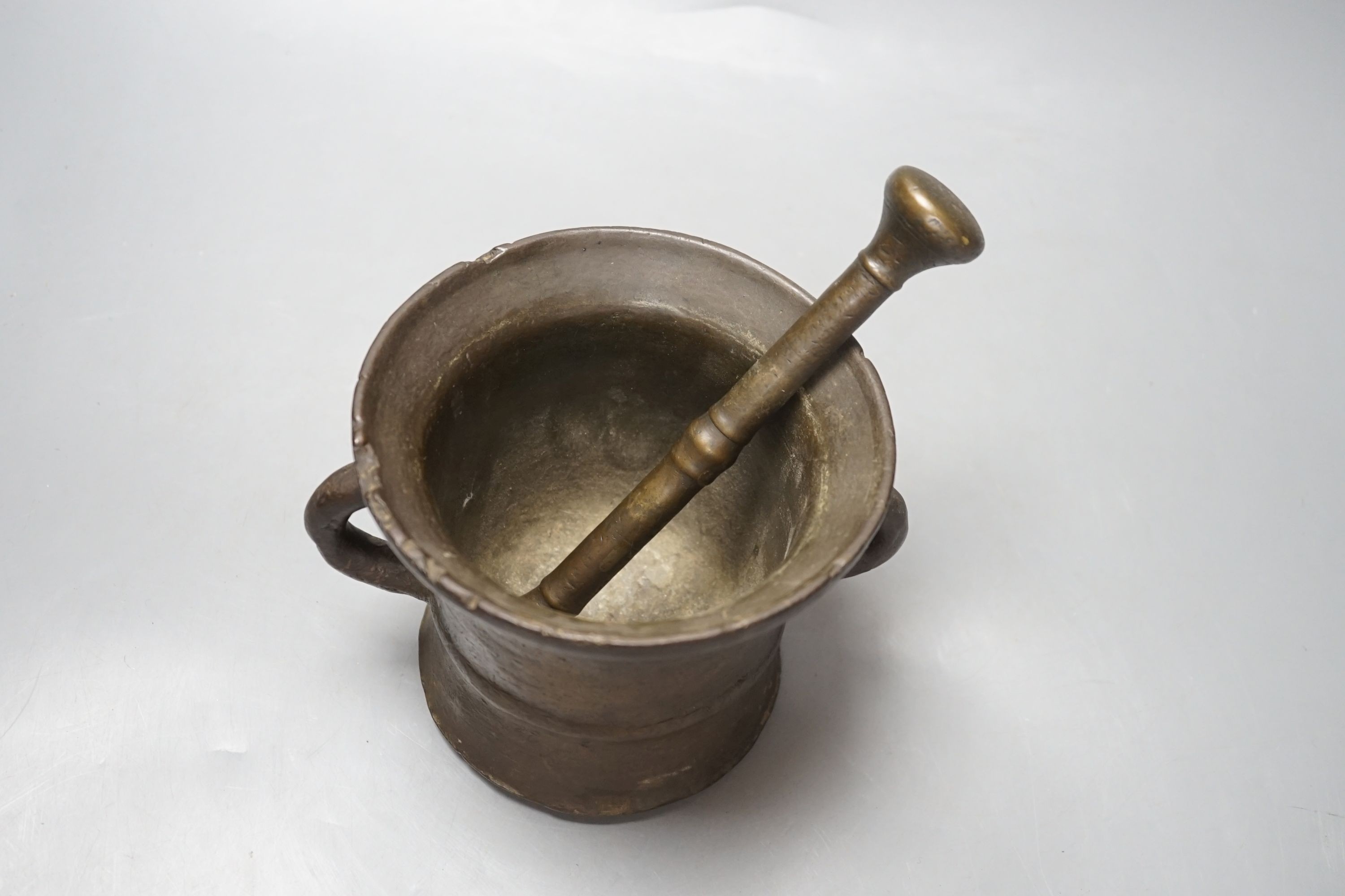 An 18th century bronze pestle and mortar